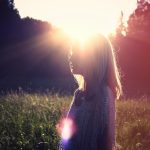 photo of woman on green grass field outdoors during daytime
